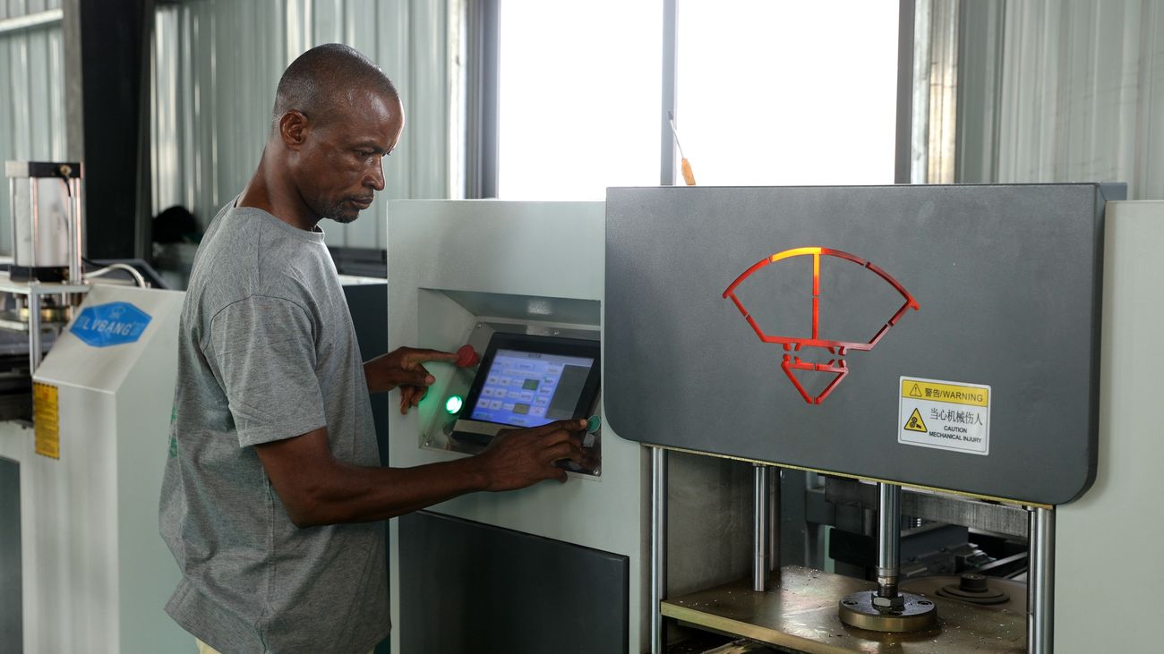 Worker at a machining centre control panel